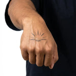 Tatuaggio semi-permanente INKON Sunrise Horizon applicato su un uomo – design 2 x 2 in (5x5cm), aspetto realistico dell'inchiostro, dura 10 giorni